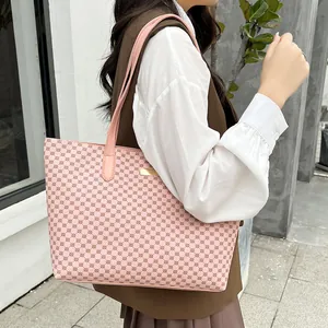 Side view of a pink tote bag with geometric pattern worn by a model against a grey wall