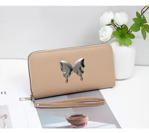 Detail of apricot faux leather wallet with silver fluid butterfly and wrist strap