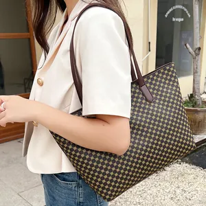 Detail of a brown vintage geometric tote bag with sturdy leather shoulder straps