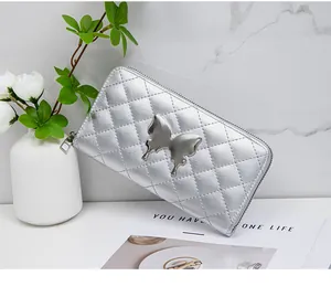 Macro view of silver quilted leather wallet with mirror butterfly metal buckle