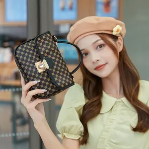 Vintage checkered satchel with gold geometric pattern and black leather trim handle