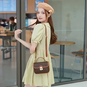 Quilted Kelly bag with vintage monogram and gold buckle shown on a female model