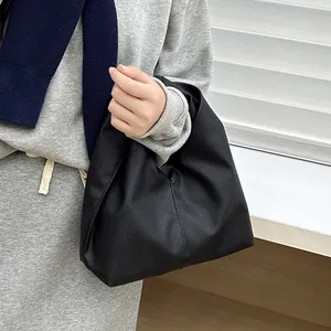 Minimalist black lychee pattern leather dumpling tote bag for women with single handle