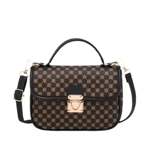 Quilted top-handle bag with brown monogram pattern and golden metal flip lock clasp