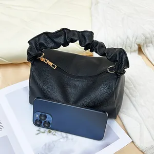 Litchi pattern black cross-body pillow bag with a ruched handle and golden hardware