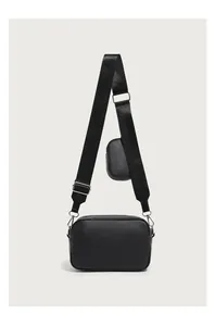 Detail of black crossbody bag set with wide nylon strap and small round coin purse