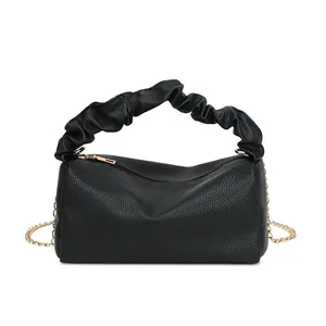 Black lychee pattern pillow bag with ruffled handle and gold chain shoulder strap