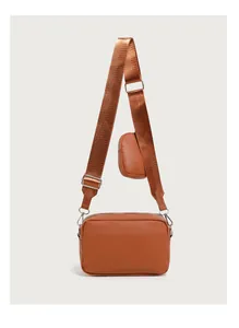 Detail of brown quilted crossbody bag with adjustable wide strap and matching mini pouch