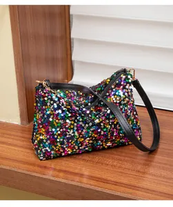 Close-up of vibrant multi-colored sequins on a stylish small handbag with gold hardware