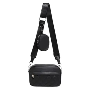 Black quilted crossbody camera bag with adjustable strap and small round coin purse