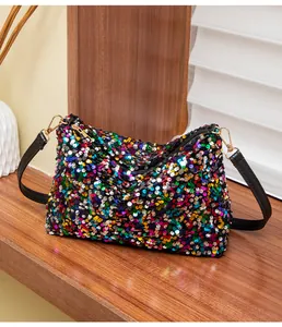 Close-up of rainbow sequins on shoulder bag with gold hardware and zipper detail