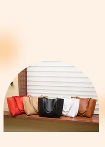 Detailed view of minimalist large tote bags in red, beige, black, white, and brown colors