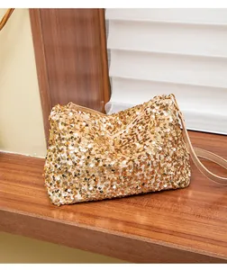 Detailed view of the sparkling gold sequins and zip closure on the fashion shoulder bag