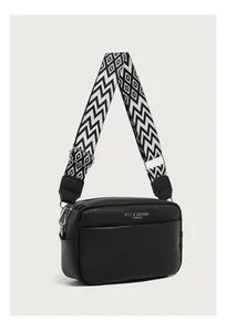 Detail of black pebbled leather crossbody bag with geometric wave pattern wide strap