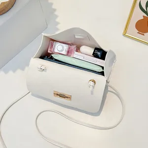 Quilted felt mini crossbody bag with gold lock showing interior storage for daily items