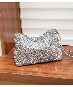 Close-up of sparkling silver sequin handbag featuring a metal zipper and fine shoulder strap