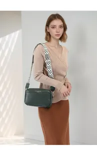Dark green leather crossbody bag with ethnic geometric wide shoulder strap detail
