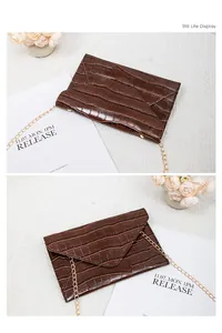 Detailed view of dark brown stone pattern envelope bag with elegant gold chain strap