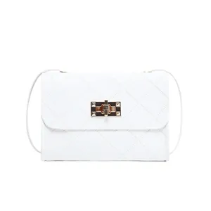 Minimalist white quilted crossbody bag with golden twist lock on clean background