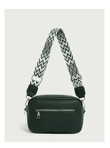 Close-up of green litchi texture shoulder bag with wide geometric woven strap