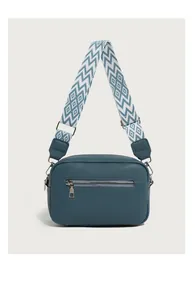 Detail of teal litchi grain leather crossbody bag with geometric wide strap and back zipper