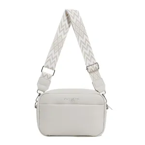 Creamy beige pebble leather crossbody bag with geometric woven wide shoulder strap
