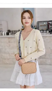 Detail of khaki chevron quilted crossbody bag with adjustable wide fabric shoulder strap