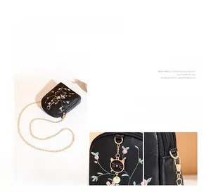 Detailed embroidery of white and pink flowers on black crossbody phone bag for women