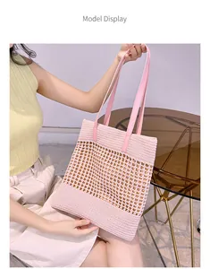 Pink woven tote bag featuring hollow mesh design and faux leather handles for summer use