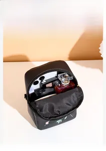 Vertical top view of black embroidered bag showing organized interior storage space