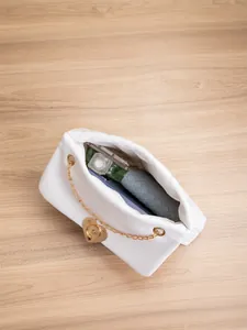 Detailed interior view of white quilted bag with heart lock showing storage capacity