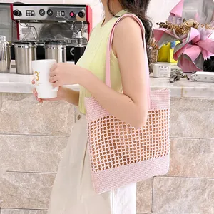 Pink handwoven straw tote bag with crochet hollow design for beach summer vacations
