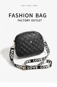 Detail of black quilted camera bag with stylish gold hardware and wide LOVE letter strap