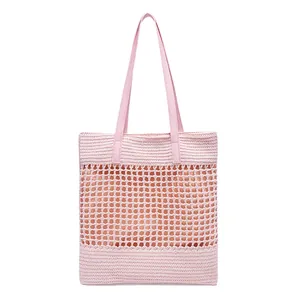 Light pink hand-woven straw tote bag with cutout mesh and leather straps for beach holidays