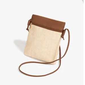 Minimalist straw woven crossbody phone bag with brown PU trim and long shoulder strap