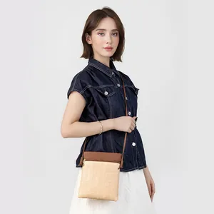 Minimalist straw woven crossbody phone bag with dark brown trim and slim shoulder strap