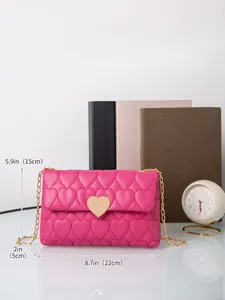 Detail showing heart-shaped quilting and gold metal heart lock on fuchsia crossbody bag