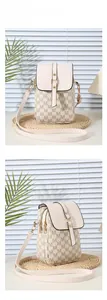 Detailed view of pink crossbody phone bag featuring a trendy letter pattern and gold buckle