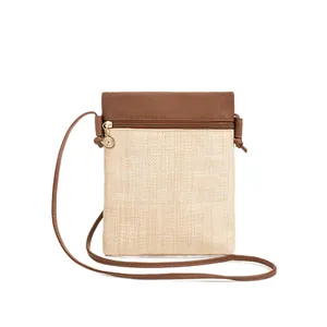 Minimalist straw woven crossbody phone bag with two-tone faux leather and gold pendant