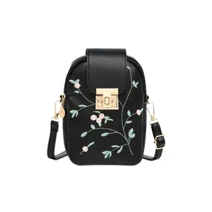 Black floral embroidered crossbody phone bag with gold clasp and adjustable strap