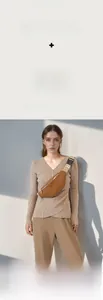 Detail of woven strap and vintage M-pattern jacquard on the brown crossbody chest bag