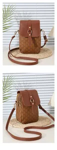 Detail of a brown PU leather crossbody phone bag with M-letter prints and gold hardware