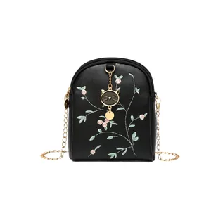 Elegant black crossbody bag with pink flower embroidery and gold chain strap on white background