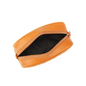 Caramel quilted leather crossbody camera bag with gold zipper and black interior lining