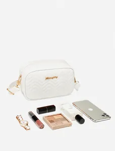 White quilted leather crossbody bag showing interior storage capacity for essentials