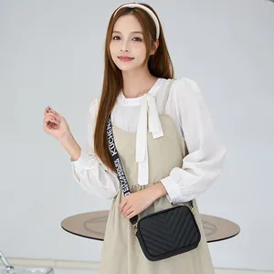 Fashionable black quilted crossbody camera bag with adjustable wide jacquard strap