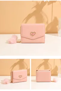 Pink short leather wallet for women with heart buckle and soft faux fur pompom detail