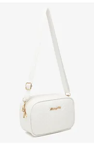 Detail of white quilted crossbody bag with golden hardware and leaf pendant charm