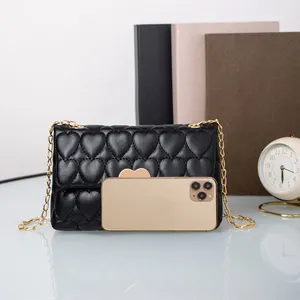 Fashionable black heart quilted crossbody bag with gold heart clasp and metal chain strap