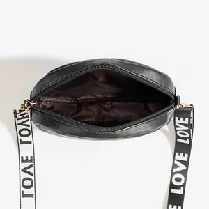 Black quilted crossbody camera bag with Love printed wide strap and zipper closure